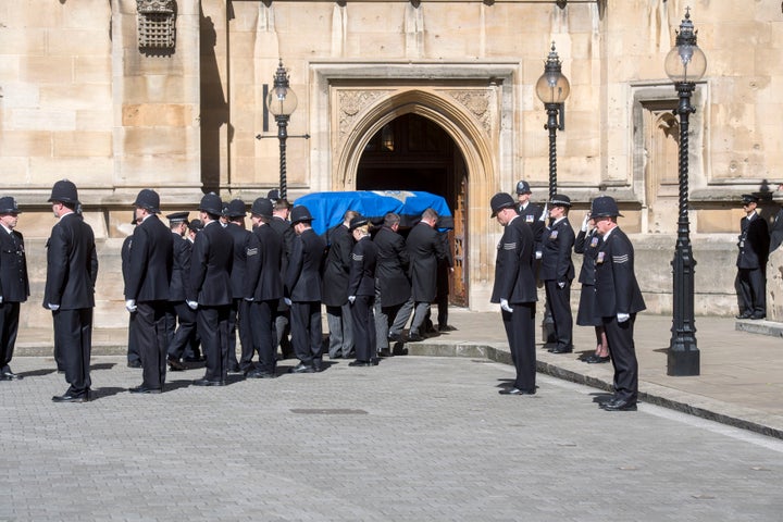 PC Keith Palmer's coffin passes a police guard of honour as it arrives at Westminster Chapel