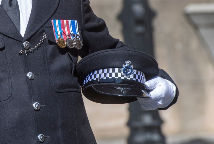 Keith Palmer's cap is held as his coffin arrives at Westminster's Chapel of St Mary Undercroft