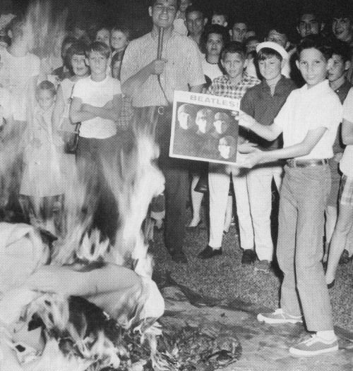 Young people burning Beatles records.