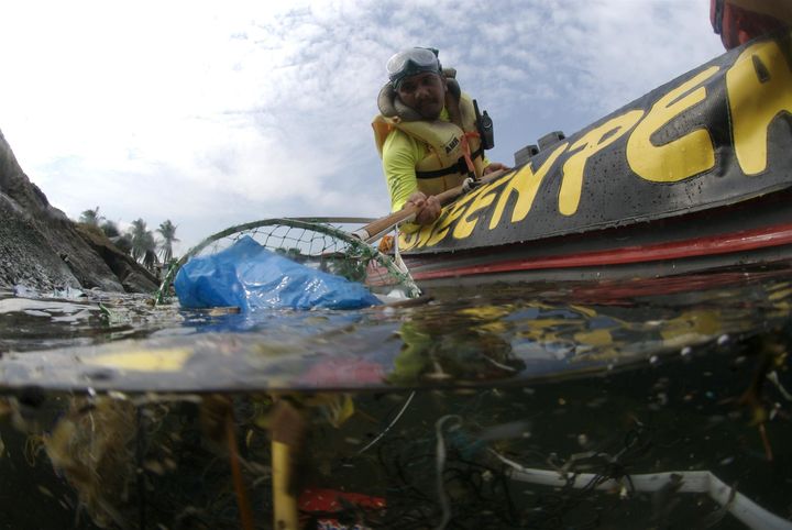Greenpeace volunteers collect plastic rubbish from Manila Bay.