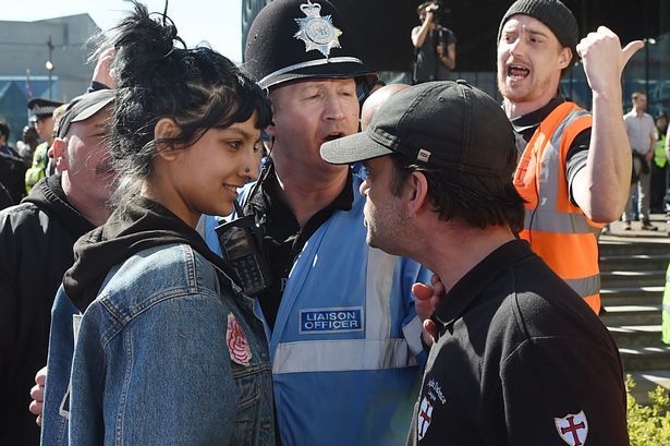 <p>Saffiyah Khan smiling at the face of the EDL leader.</p>