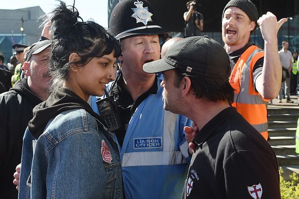 Saffiyah Khan smiling at the face of the EDL leader.