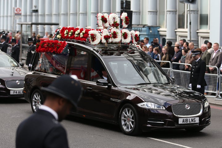 <strong>Police officers line the route as the hearse carrying the coffin of PC Keith Palmer passes by</strong>