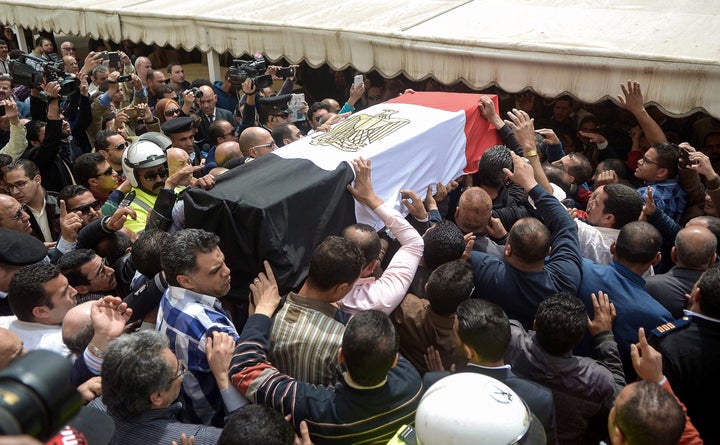 Egyptians carry the coffin of policewoman Brigadier Nagwa el-Haggar during her funeral on April 10, 2017, after she died during a blast that struck outside the Coptic Orthodox Patriarchate headquarters in the Mediterranean city of Alexandria on Palm Sunday the day before.