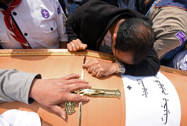 Mourners carry the coffin of a victim of the bombing at Saint Mark's church in Alexandria on April 10, 2017.