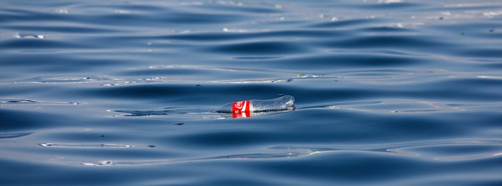 A Coke bottle floats in the Pacific Ocean.