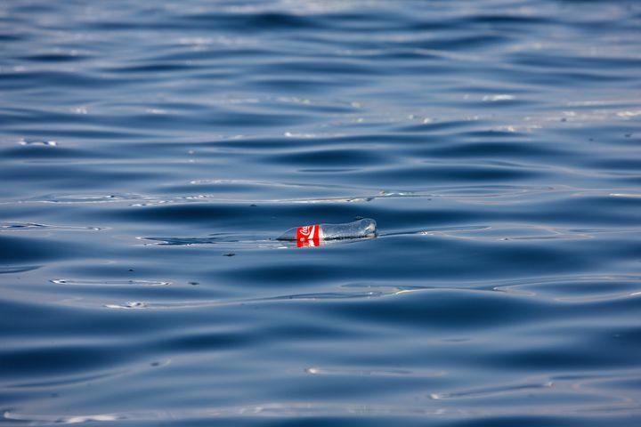 A Coke bottle floats in the Pacific Ocean.