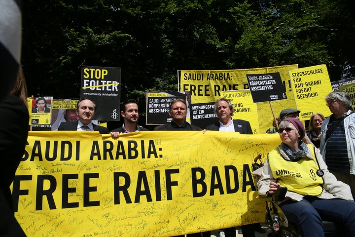 Amnesty International activists held a protest demanding the release of blogger Raif Badawi and to stop torture, in front of