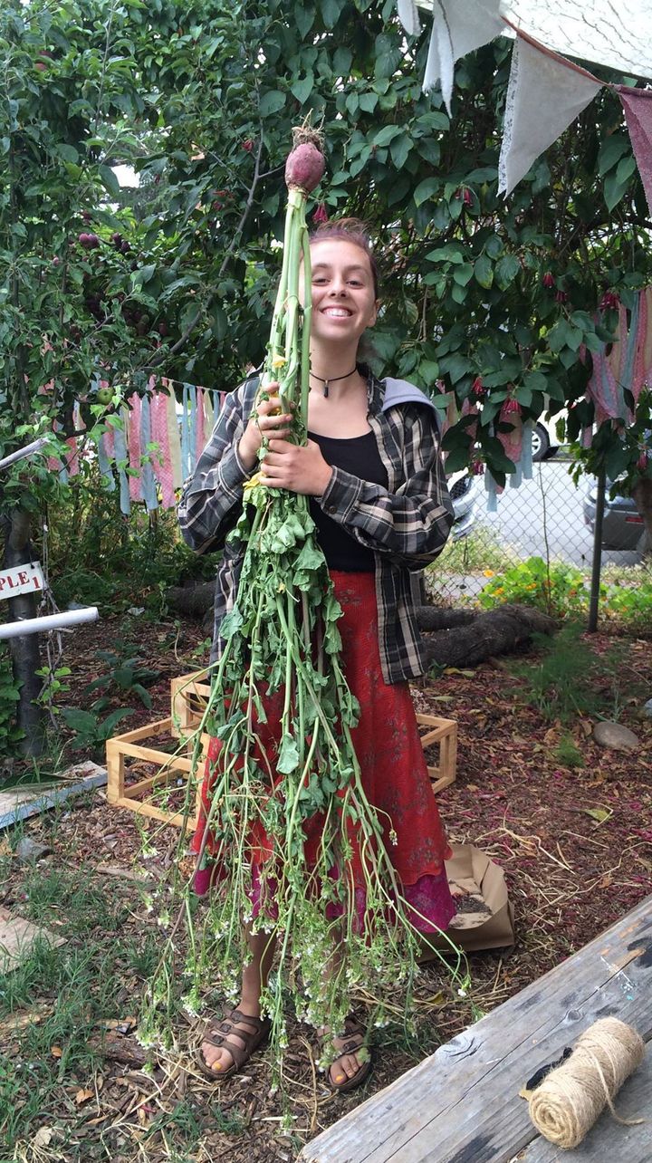 Senior, Alex Raffanti, shows off one of the many vegetables harvested in the garden.