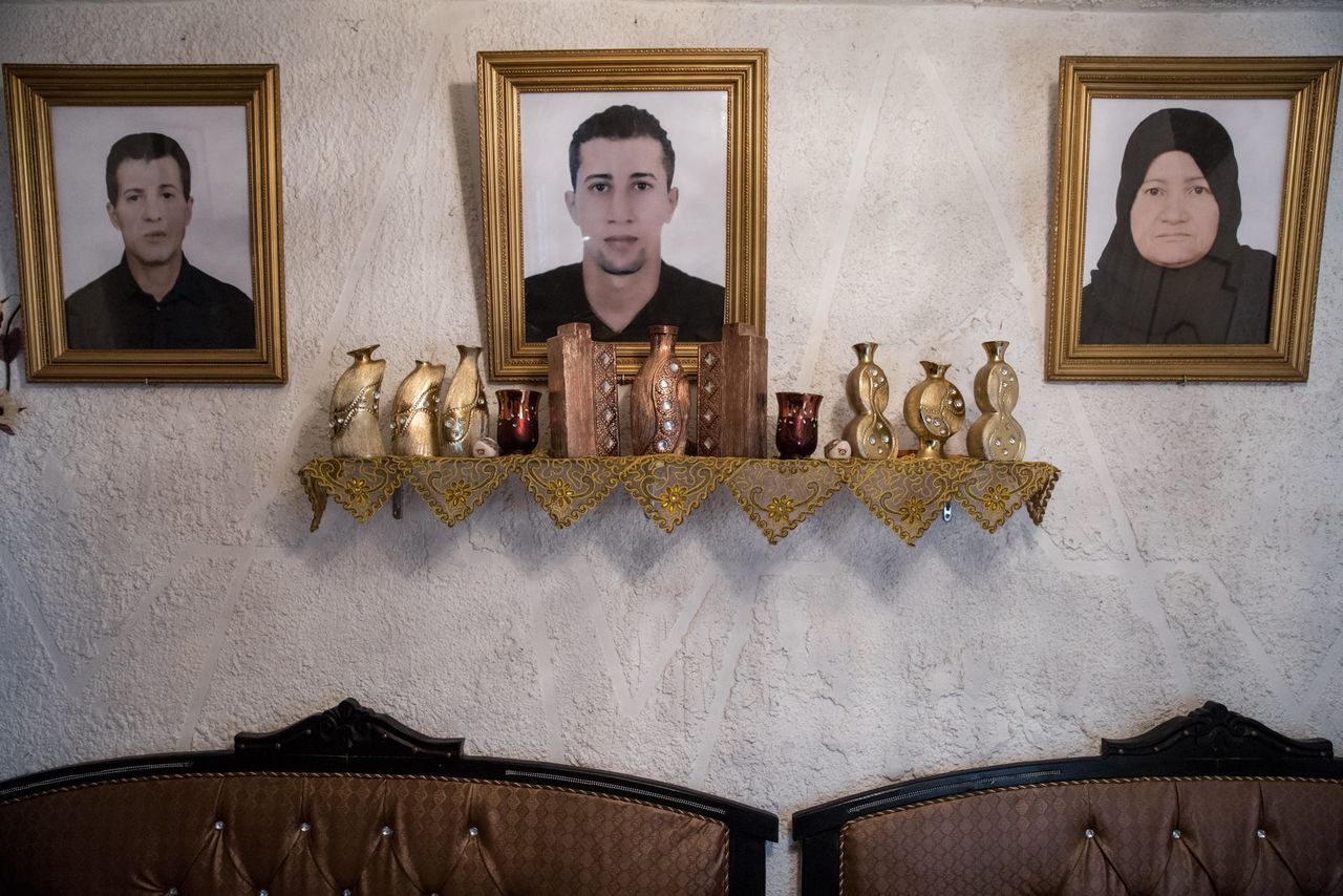 A portrait of Mohammad (center), who left Tunisia to join an extremist group in Syria and never returned, hangs in his family's house in the Ettadhamen neighborhood of Tunis.