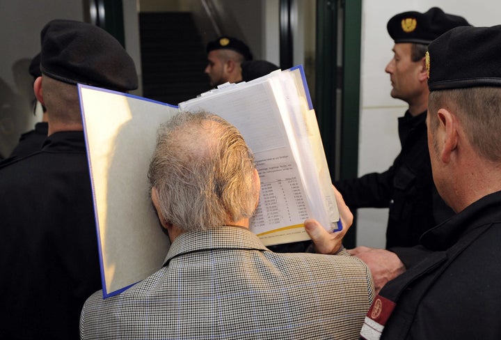 Fritzl trying to hide his face as he arrived for his trial in 2009 