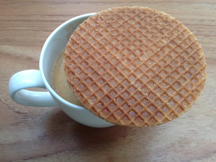 A stroopwafel served on top of a coffee.