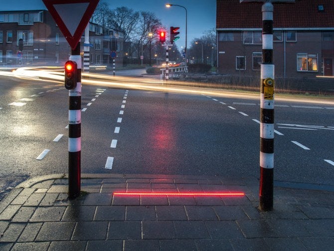 A LED light strip has been set up in a small Dutch town to assist those pedestrians who are glued to their smartphones.