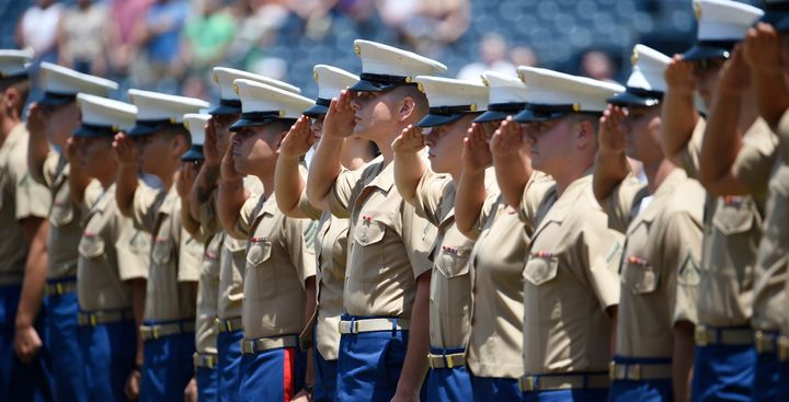U.S. Marines salute during the national anthem before a baseball game between the San Diego Padres and the Cincinnati Reds on July 31, 2016. 