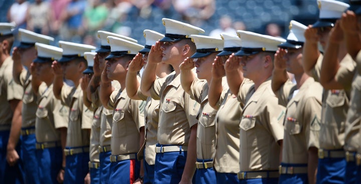 U.S. Marines salute during the national anthem before a baseball game between the San Diego Padres and the Cincinnati Reds on July 31, 2016.
