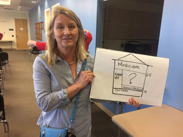 Dr. Kristine Hembre with the graphic she used to explain health care costs to Lamborn.