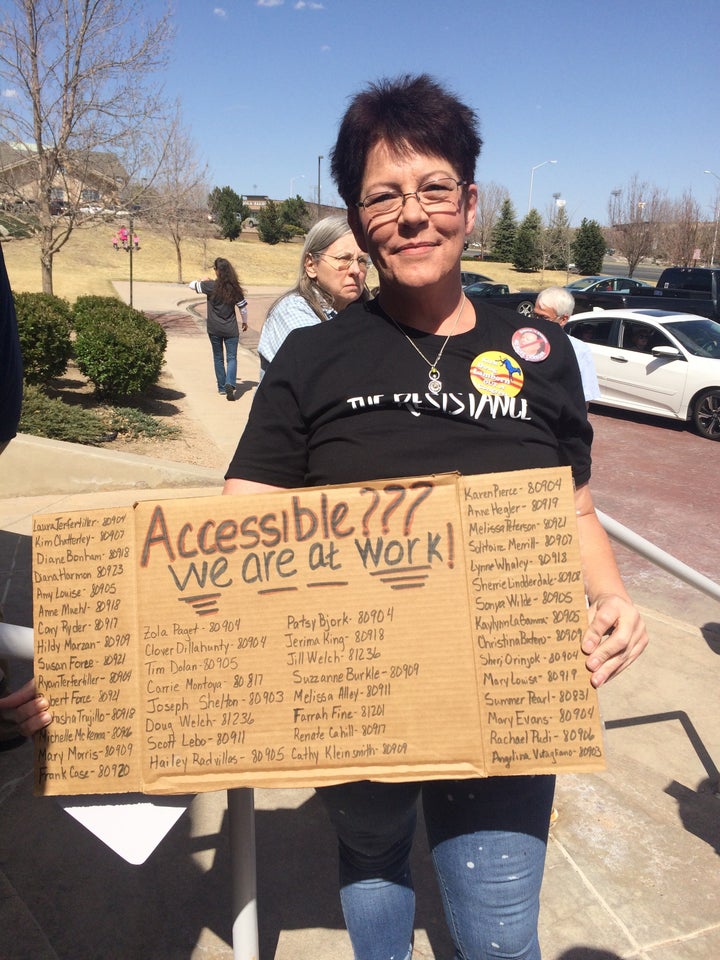 Betty Field poses with her sign outside the venue.