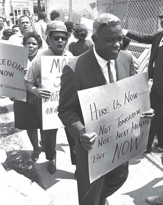 Jackie Robinson marching in a civil rights protest