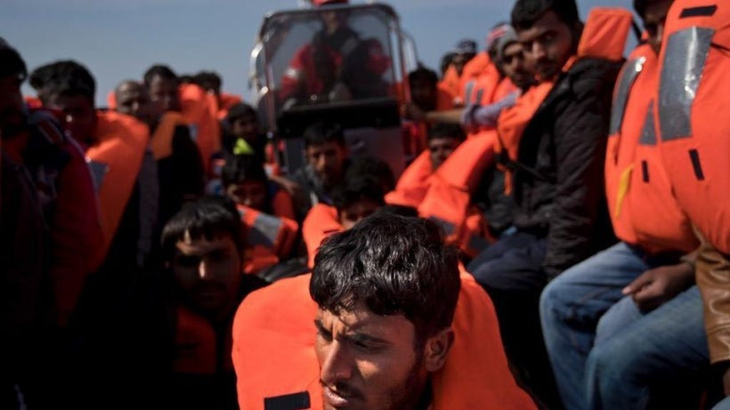 Migrants are rescued from a rubber boat, ‘dinghy,’ by members of <a rel="nofollow" href="https://www.proactivaopenarms.org/"