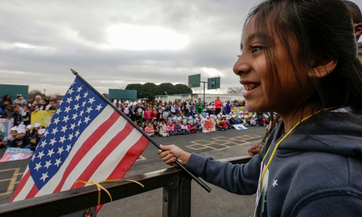 Alexandra Rojas, a 5th grader, holds a flag at an annual Stepping Out for Peace March held by students to mark Martin Luther King Jr.'s birthday on January 15, 2016 in Los Angeles.
