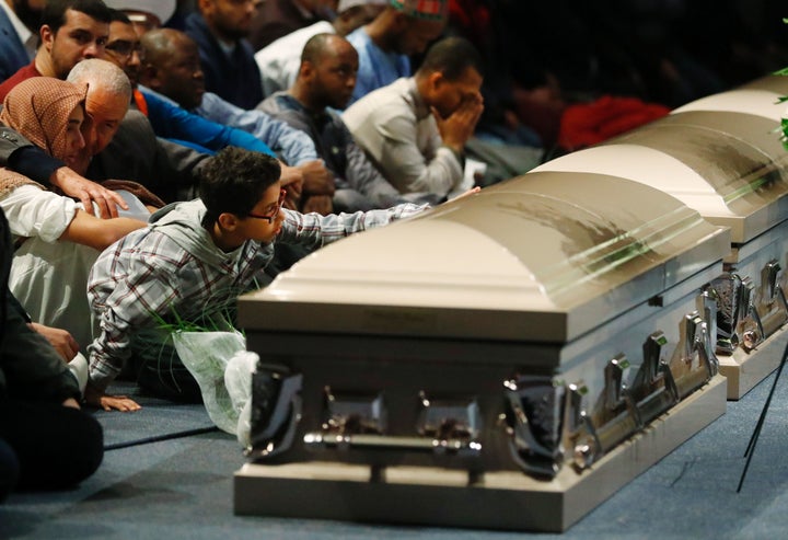 People mourn at a February funeral service for three victims of the Quebec mosque shooting.