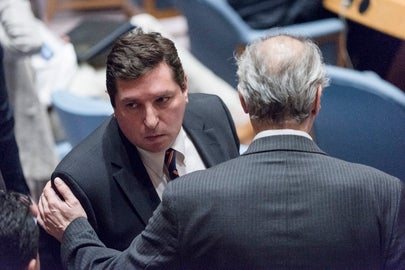 Russia’s Vladimir Safronkov talks to Syria Ambassador Bashar Ja’afari after meeting ended.