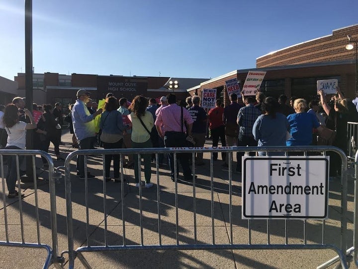 Protesters were confined to a fenced-off area outside Rep. Leonard Lance's town hall meeting in New Jersey.