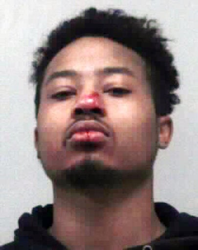 Demetrius Bryan Hollins, 21, is shown in bystander video being pulled from a car, handcufffed and placed face-down on a road, where an officer appears to kick him in the head.