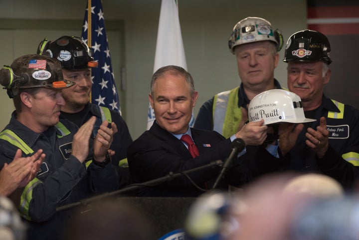 Environmental Protection Agency Administrator Scott Pruitt holds up a miner's helmet that he was given after speaking with coal miners at the Harvey Mine on April 13, 2017, in Sycamore, Pennsylvania. The Harvey Mine, owned by CNX Coal Resources, is part of the largest underground mining complex in the United States.