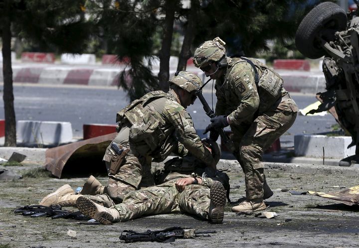 U.S. troops attend to a wounded American soldier after a bomb blast in Kabul, Afghanistan, in June 2015.