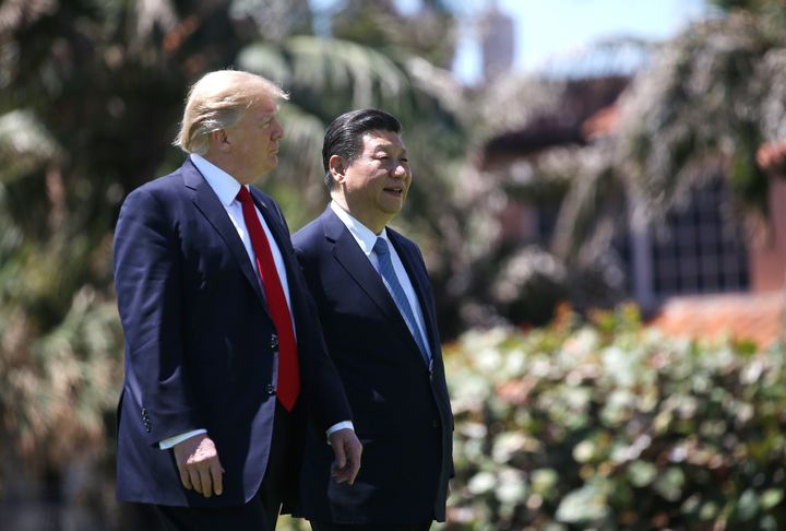 President Donald Trump, left, and China's President Xi Jinping walk along the front patio of the Mar-a-Lago estate after a bilateral meeting in Palm Beach, Florida, on April 7, 2017.