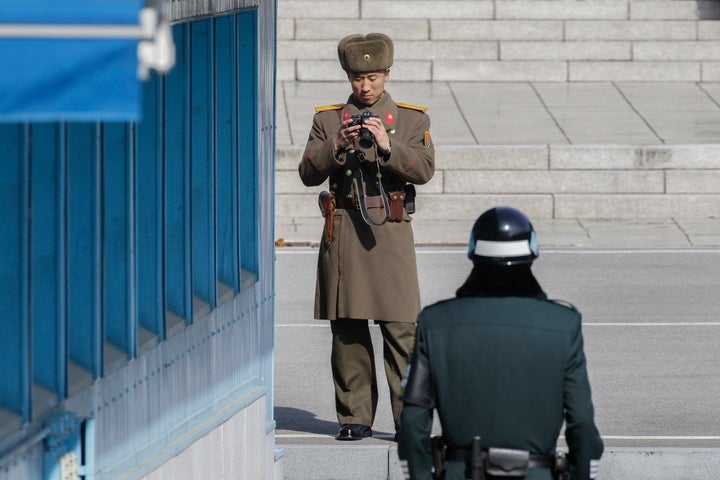 A North Korean solider and a South Korean soldier stand guard at the demilitarized zone.