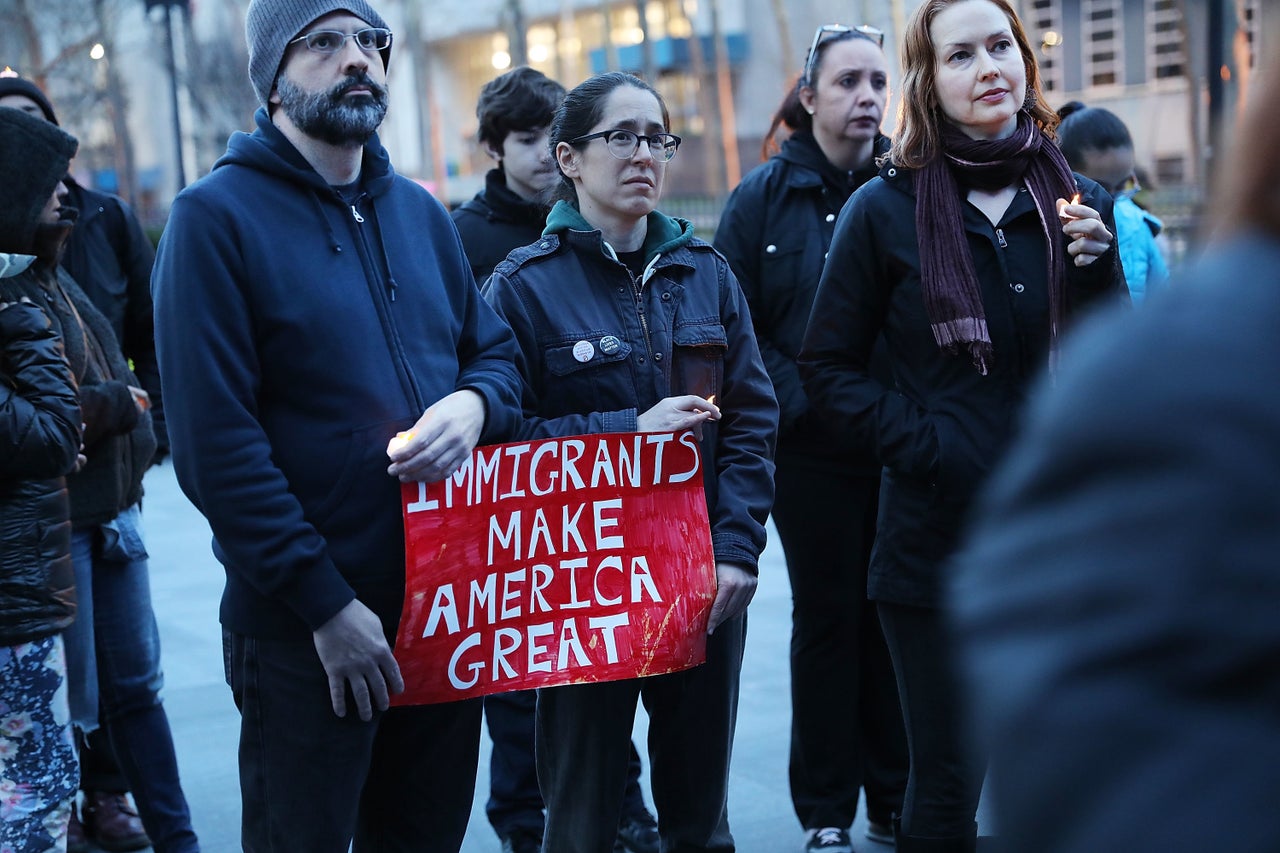 People attend a rally and vigil at Brooklyn's Borough Hall against President Donald Trump's immigration policies on April 9 in New York City. 