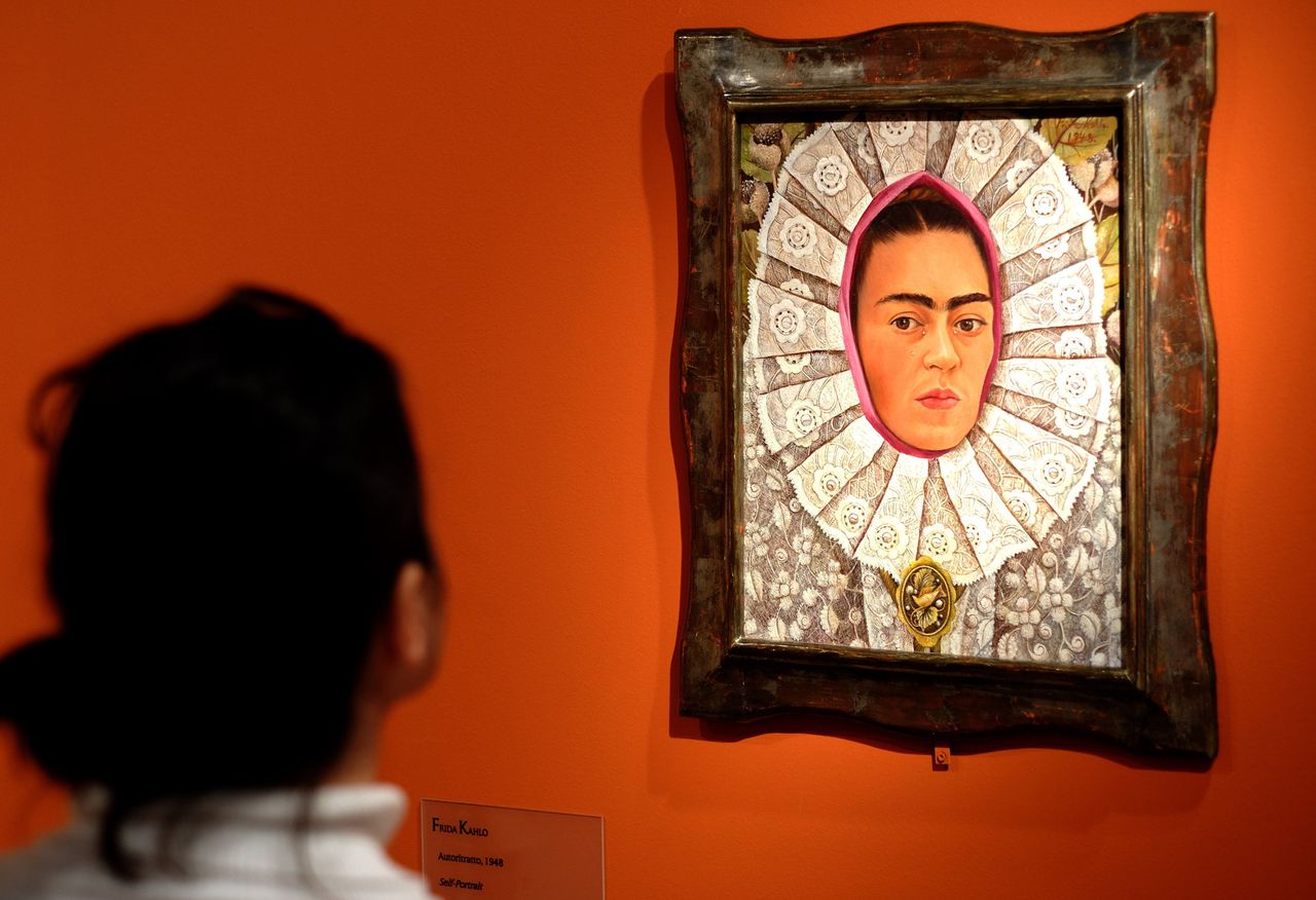 A visitor looks at "Self-Portrait" by Frida Kahlo during an exhibition in Rome.