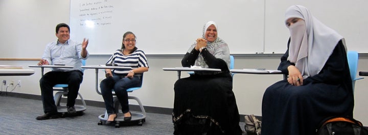 Members of local immigrant communities lead a lesson with students in City Stay.