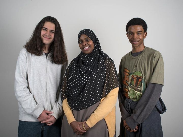 Two City Stay students pose with their host mom on the first night of their stay with a Somali family.