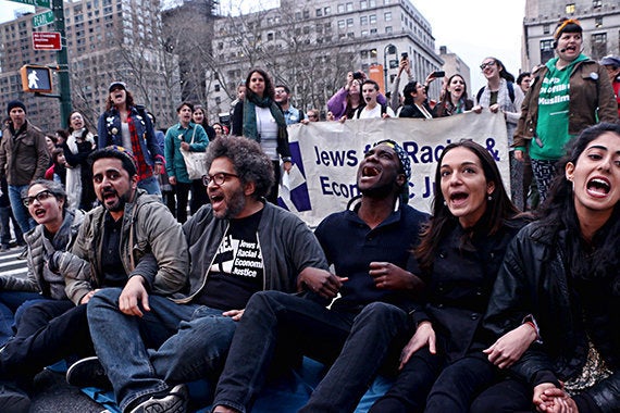 Six protestors from the JFREJ group (seated) were arrested Thursday after participating in a rally.