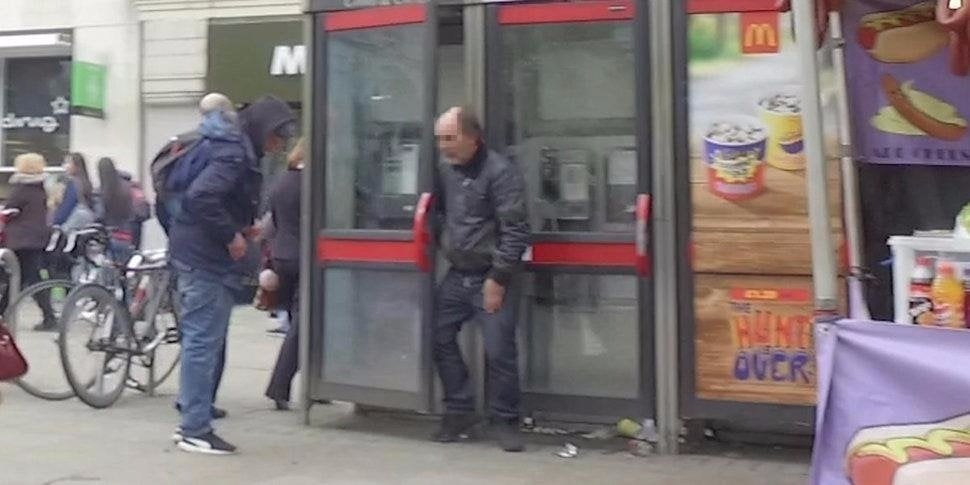 A man stands dazed after receiving a bag of an unknown substance near a phone box on Piccadilly Gardens in Manchester this week