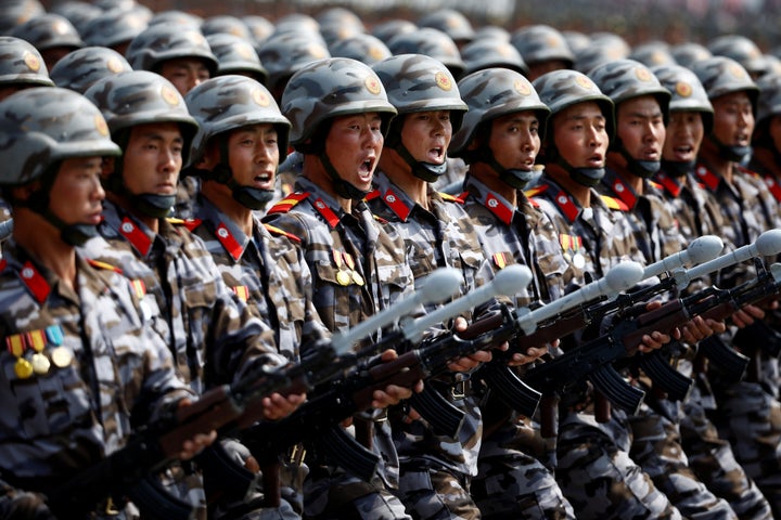 North Korean soldiers march and shout slogans during a military parade marking the 105th birth anniversary of country's found