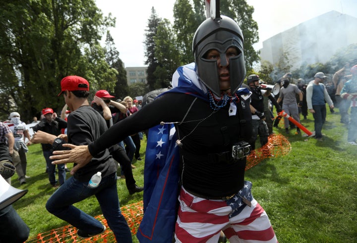 A pro-Trump protester breaks up a scuffle during the Patriots Day Free Speech Rally in Berkeley, California, U.S. April 15, 2017.