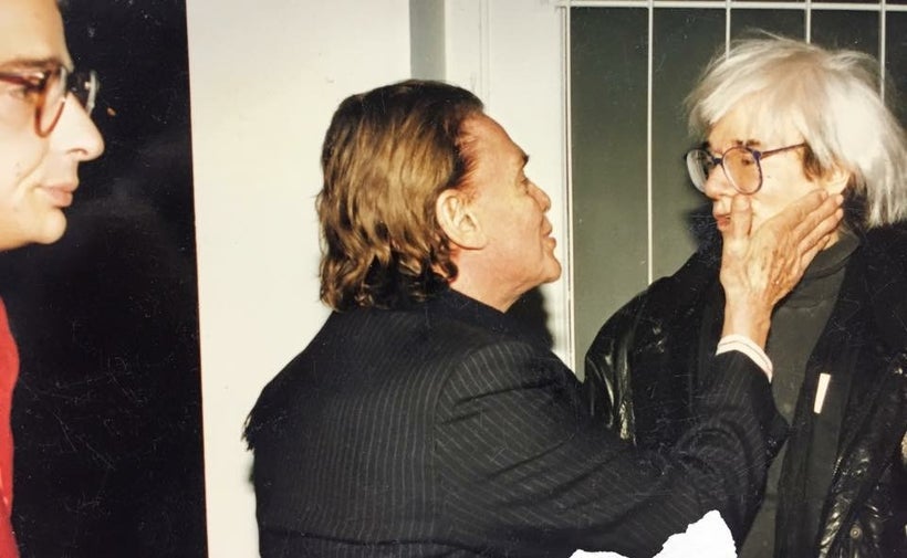 Iolas embracing Andy Warhol with an onlooking N. Stathoulis