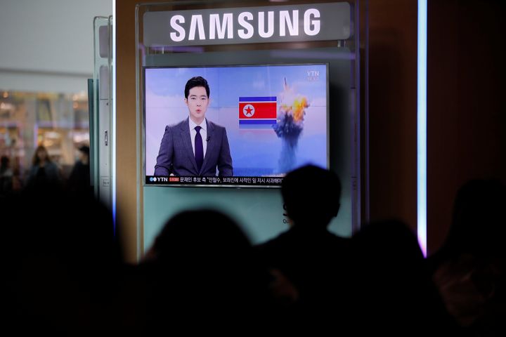 People watch a TV broadcasting a news report on North Korea's failed missile launch from its east coast, at a railway station in Seoul, South Korea