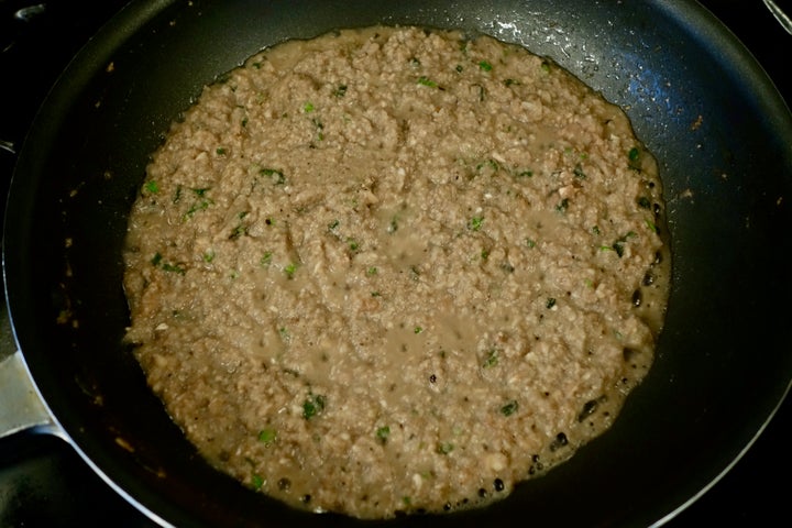 Ten ounces of supermarket mushrooms, food-processed with parsley and sage, and cooking down with butter