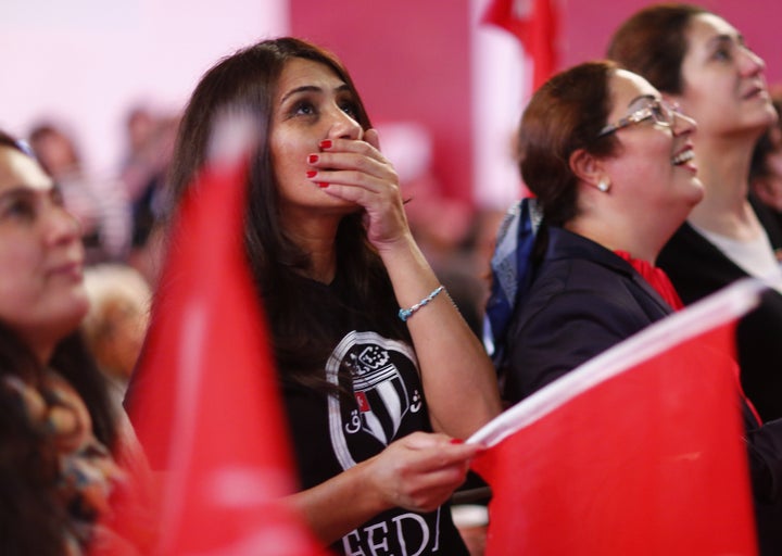 People of the Turkish community living in Germany react after first news bulletins on the outcome of Turkey's referendum on t