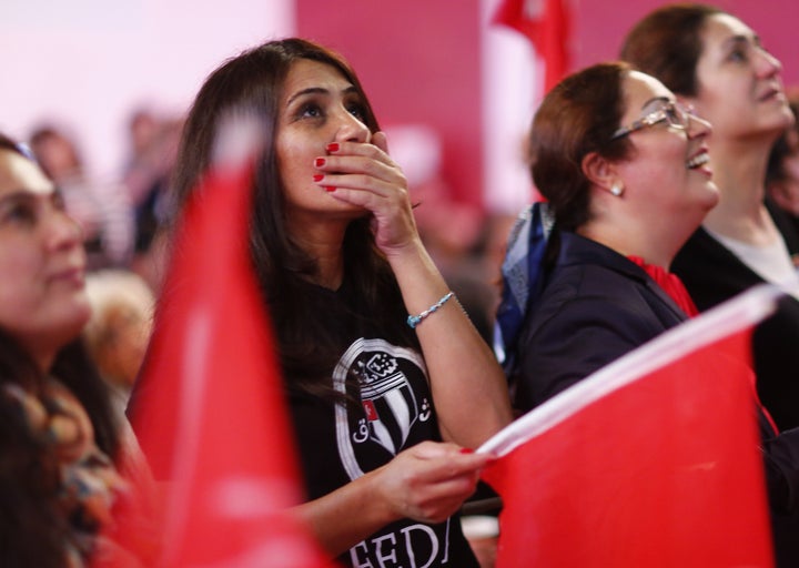 People of the Turkish community living in Germany react after first news bulletins on the outcome of Turkey's referendum on the constitution in Berlin, Germany,. 