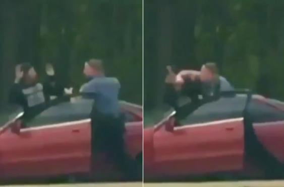 Demetrius Hollins is seen being punched in the head just after he exits his vehicle with his arms raised.