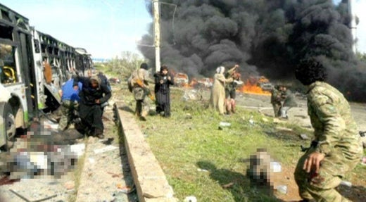 A soldier rushes to the aid of victims after a suicide bomber attacked a convoy of villagers fleeing from rebel-held Foua and