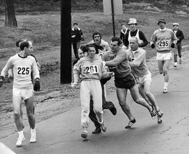 Kathrine Switzer of Syracuse, New York, was spotted early in the Boston Marathon by Jock Semple, center right. He tried to rip the number off her shirt and remove her from the race.