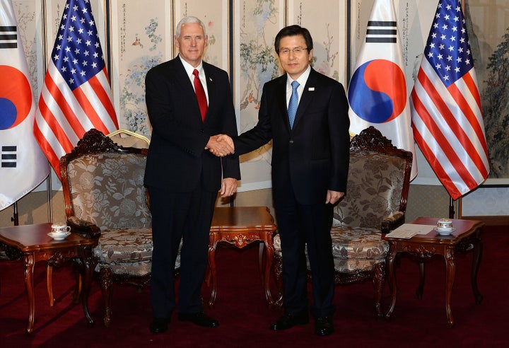 Vice President Mike Pence shakes hands with South Korean acting president and prime minister Hwang Kyo-ahn during their meeti