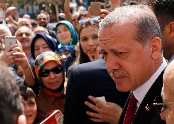 Turkish President Recep Tayyip Erdogan talks to supporters as he arrives at Eyup Sultan mosque in Istanbul, Turkey, April 17,
